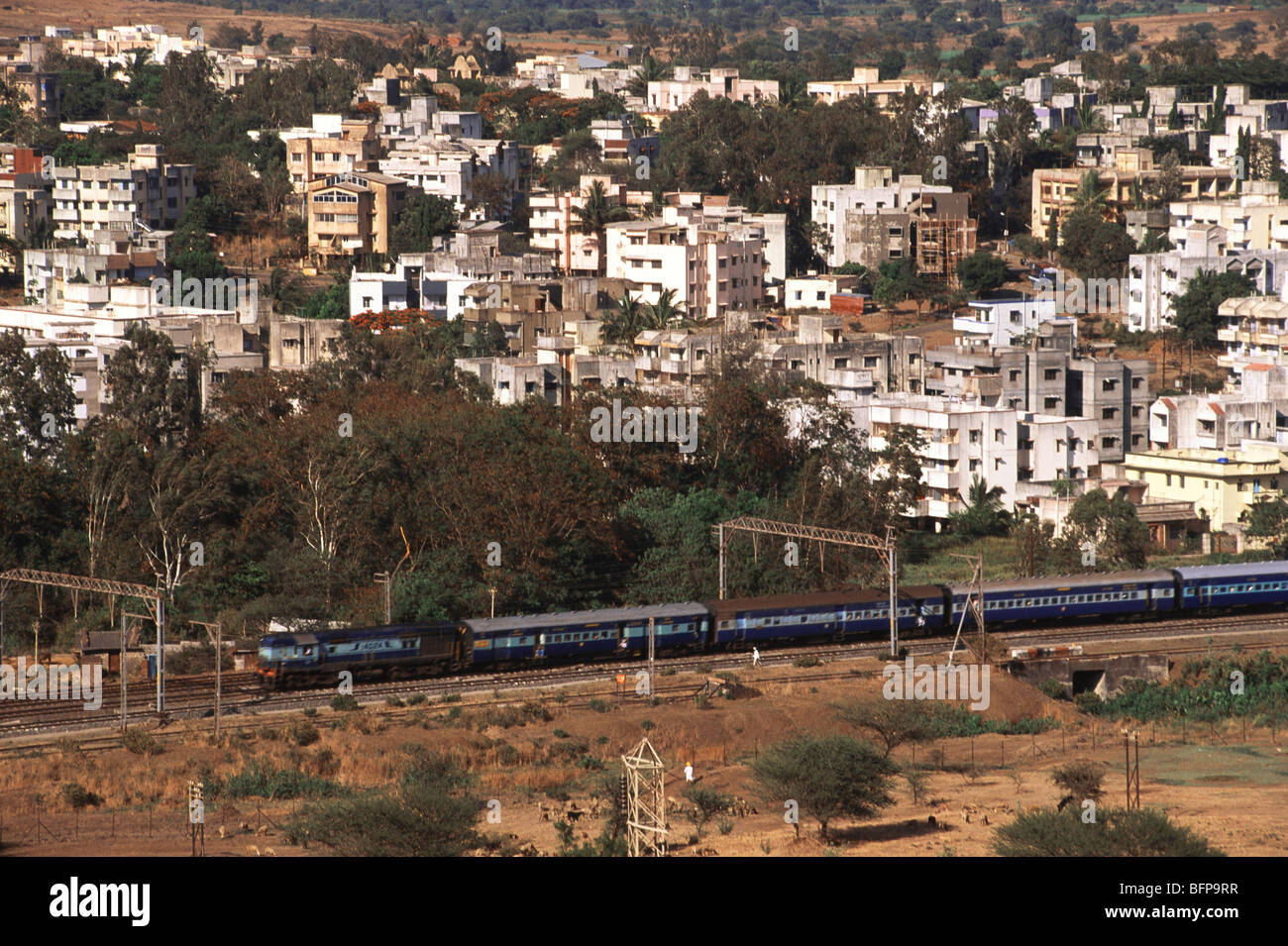 NMK 65300 : Aerial view of dense buildings & railway track with Deccan Express Talegaon ; Pune ; Maharashtra ; India Stock Photo