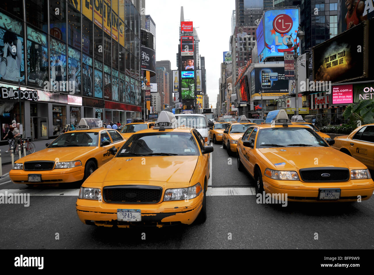 Yellow cabs hustle to first of the line in Times Square, New York