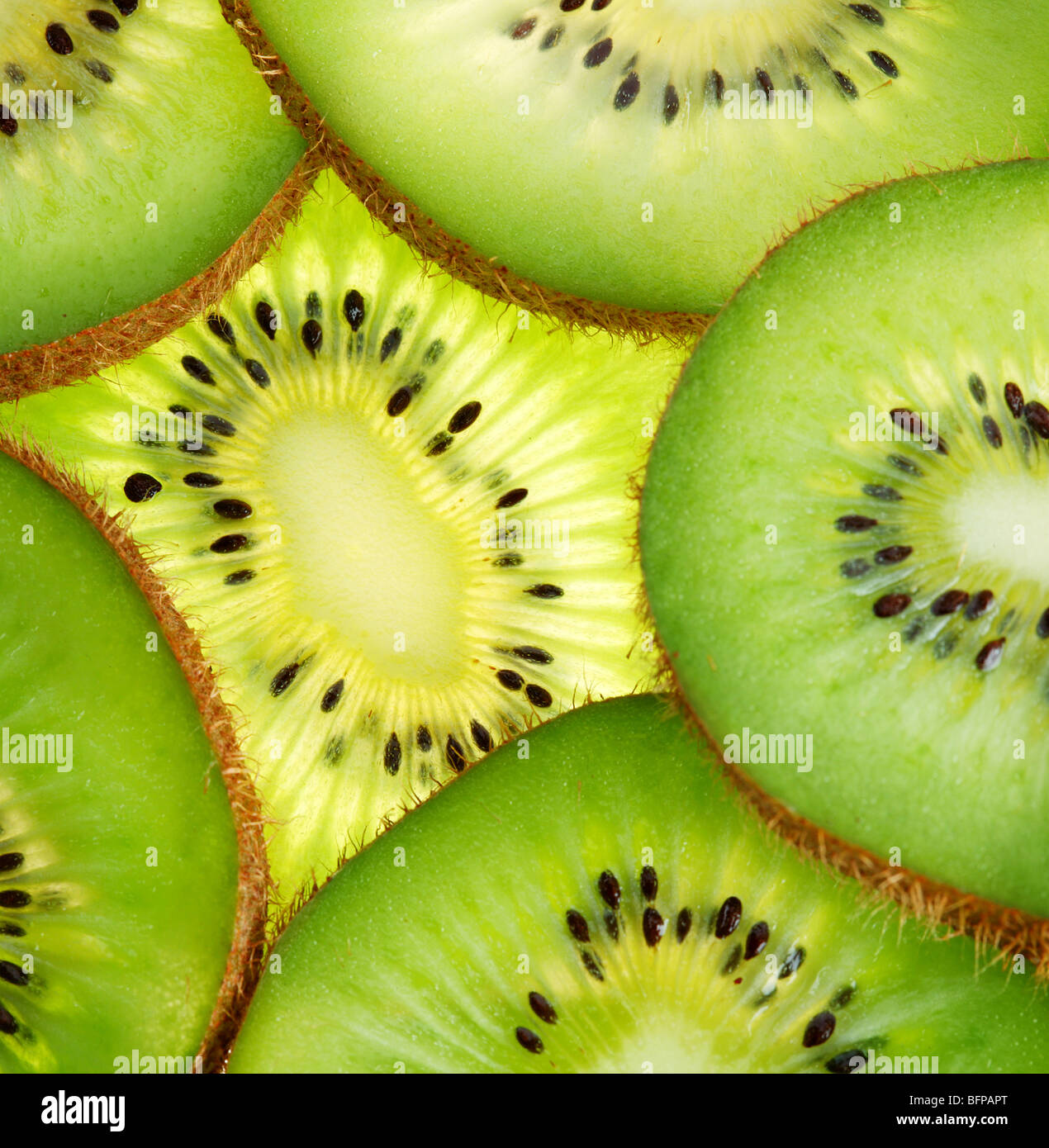 Back projected (lighted) cross sections of kiwi Stock Photo