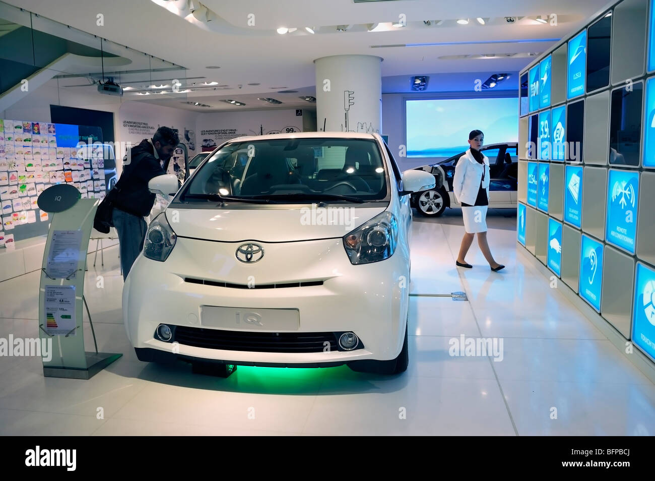 Paris, France, Man Shopping in New Car Showroom, Toyota Car, IQ, Hybrid Engine, electric cars Stock Photo
