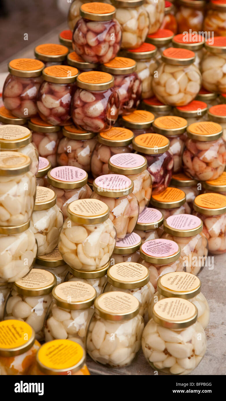 Home made organic pickled garlic jars wit various different sauces at