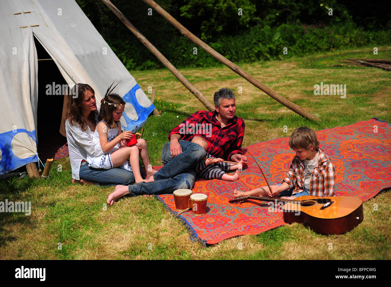 a family on a tipi wigwam camping holiday vacation in Cornwall UK Stock Photo
