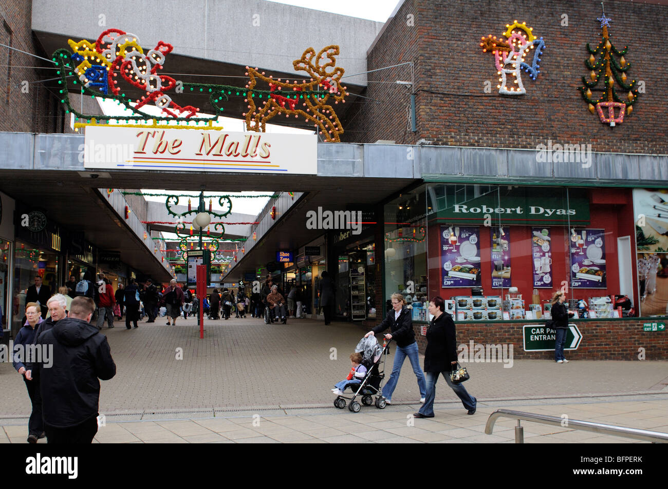 Christmas shoppers and decorations on Old Basing Mall Basingstoke Hampshire England Stock Photo