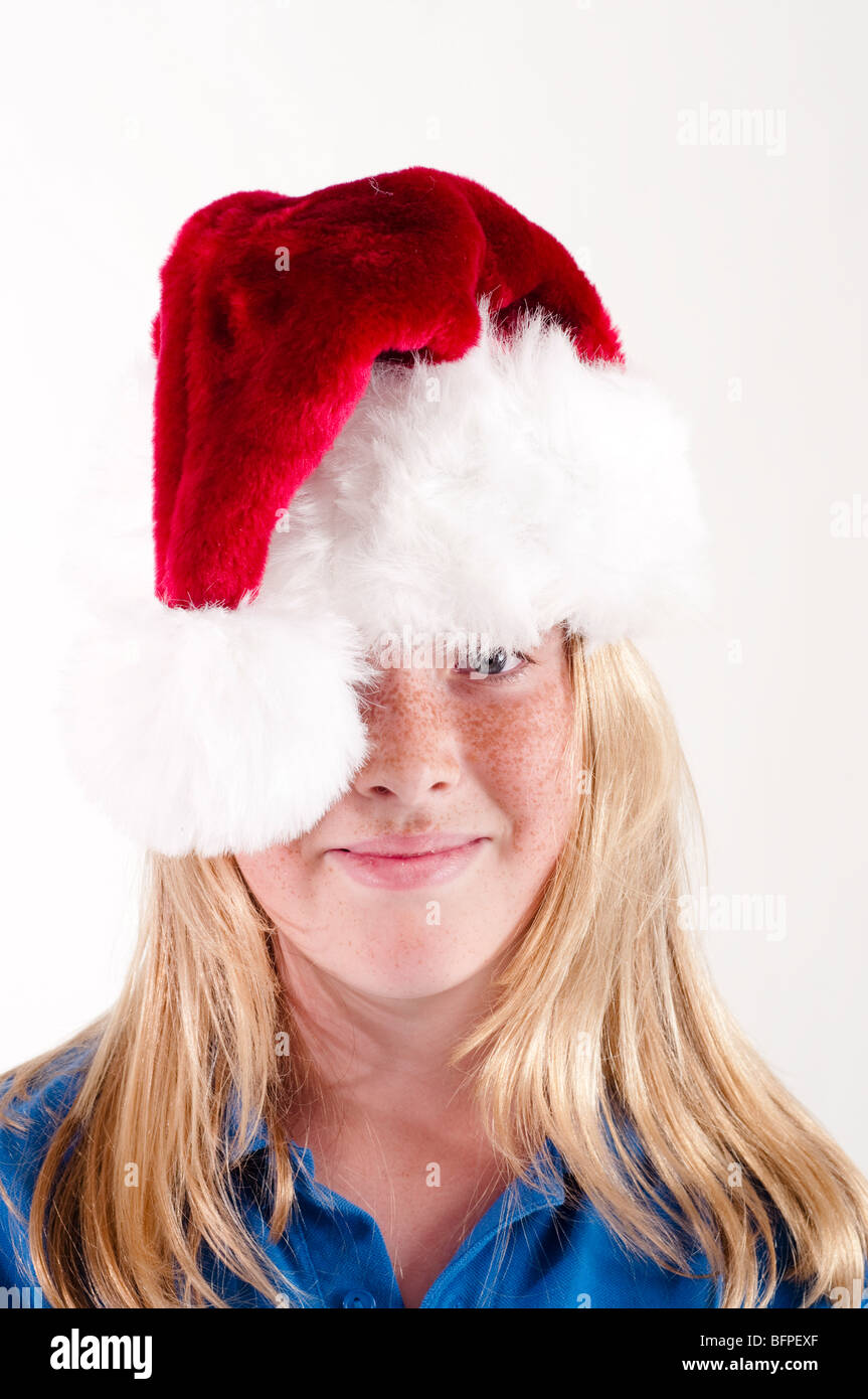Girl wearing Santa hat on head and smiling Stock Photo Alamy