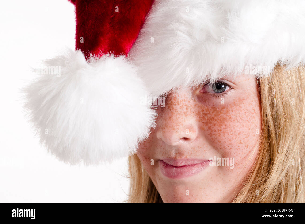 Girl wearing Santa hat on head and smiling Stock Photo Alamy