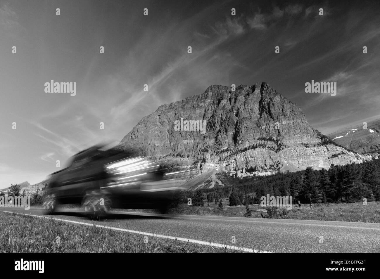 Car on the road in the Many Glaciers area of the Glacier national park