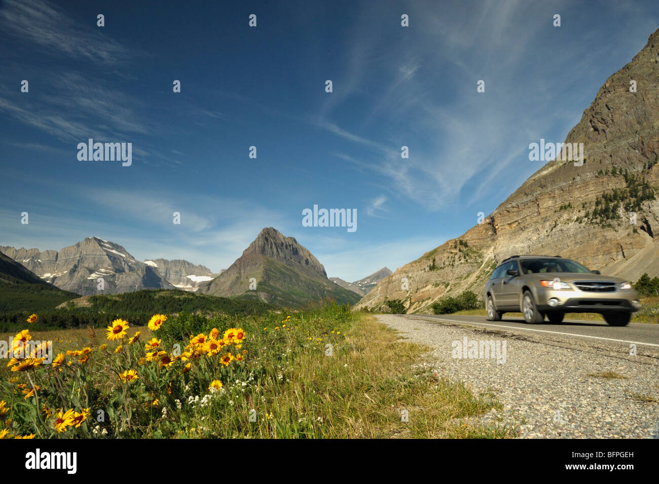 Car on the road in the Many Glaciers area of the Glacier national park