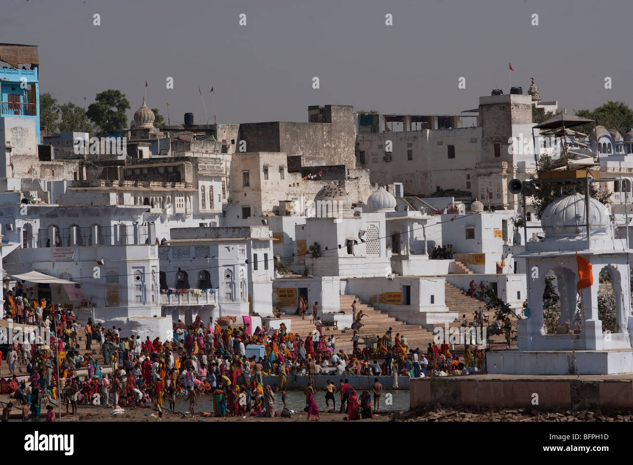 A view of old buildings, temples and pilgrims having their bath near Pushkar  lake, Rajasthan India. Stock Photo