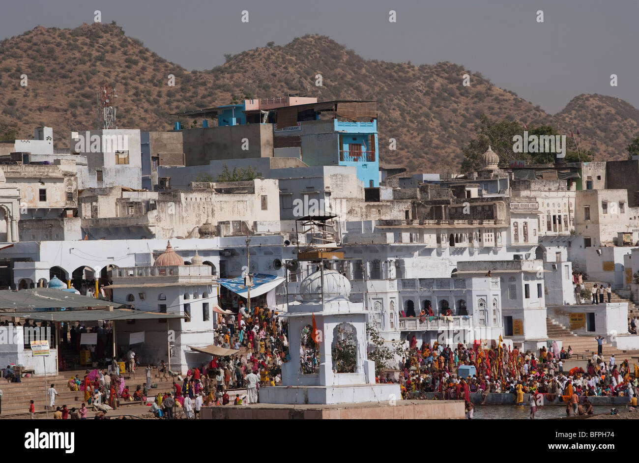 A view of old buildings, temples and pilgrims having their bath near Pushkar  lake, Rajasthan India. Stock Photo