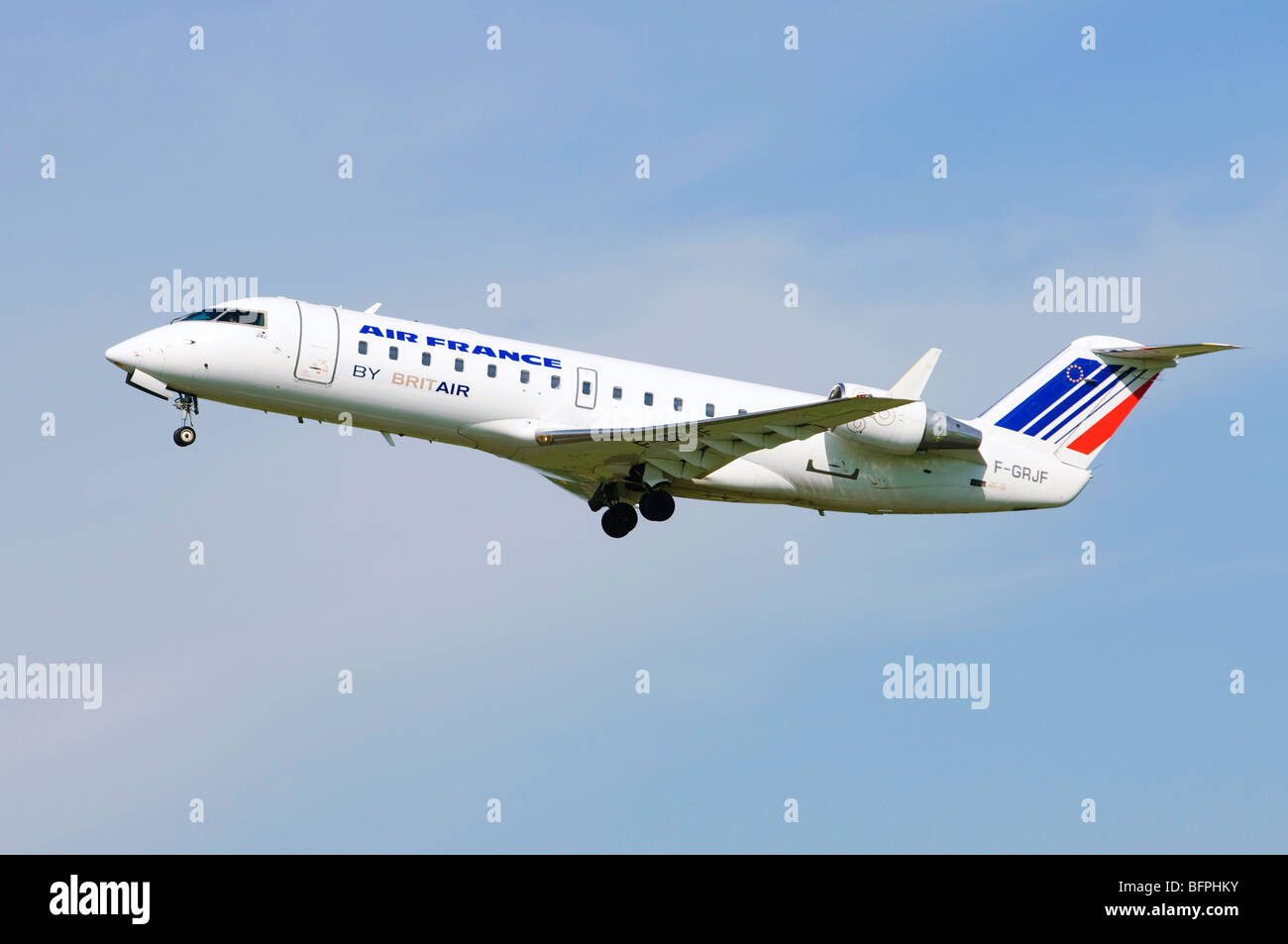 Bombardier Canadair CRJ-100 operated by Brit Air on behalf of Air France climbing out from take off at Birmingham Airport, UK. Stock Photo