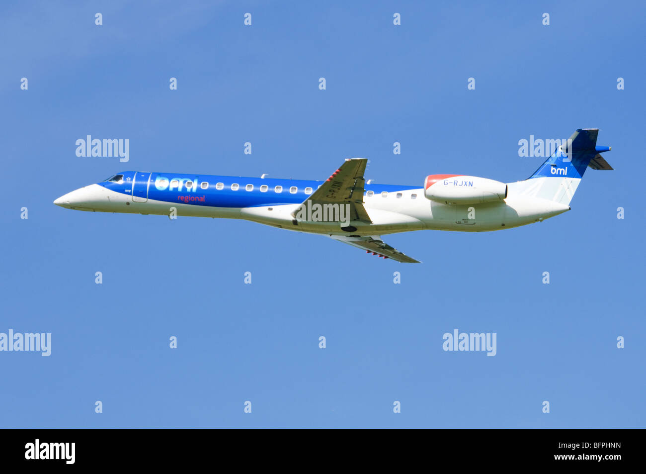Embraer ERJ-145 operated by BMI  climbing out after take off from Birmingham Airport, UK. Stock Photo