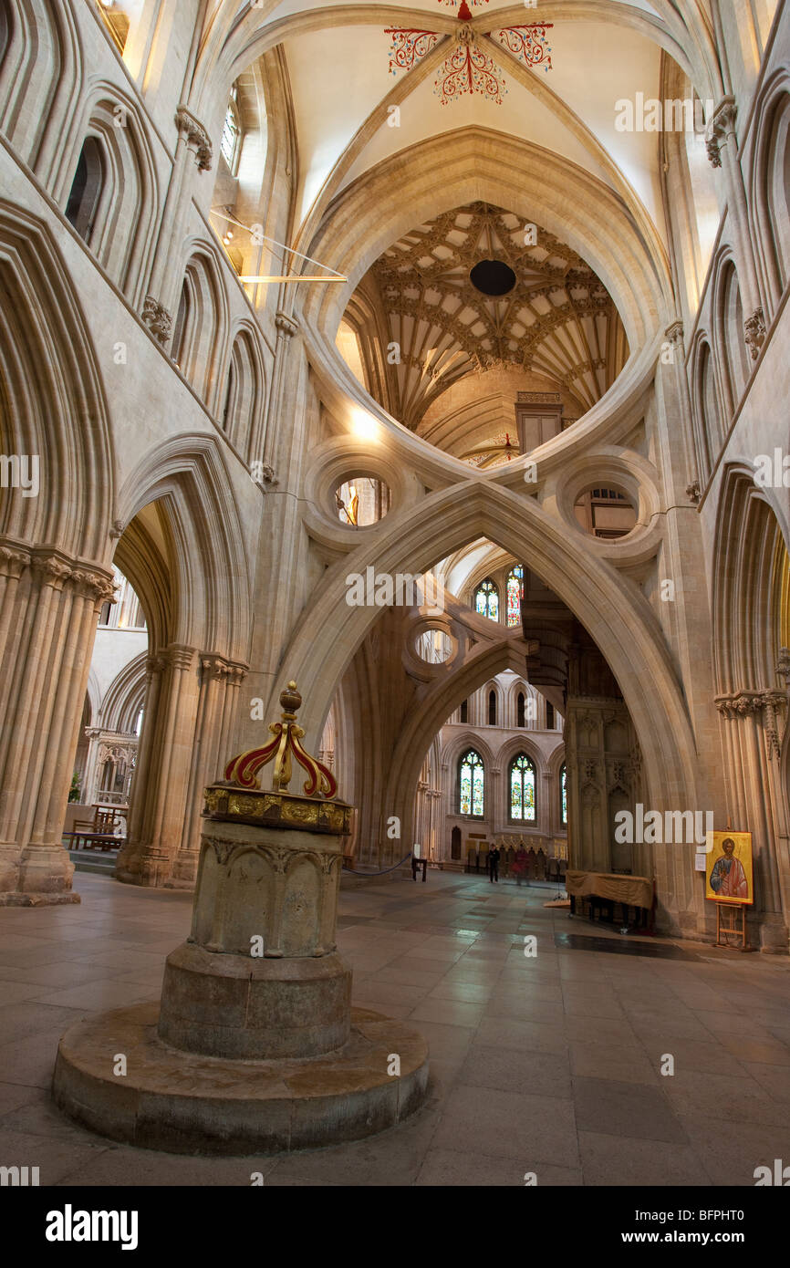 Saxon baptismal font dating from 700 AD scissor arches interior 14th century Wells Cathedral Somerset England UK United Kingdom Stock Photo