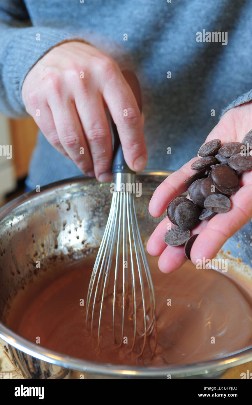 Cooking food drink- man whisking in bits of chocolate to make hot cocoa Stock Photo