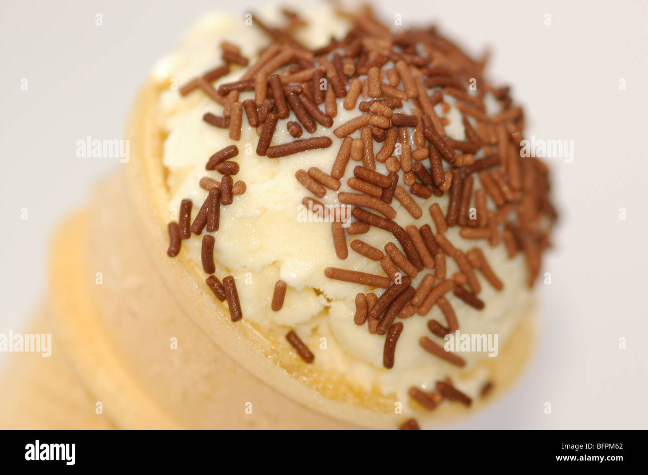 Close up of an ice cream with chocolate hundreds and thousands. Stock Photo