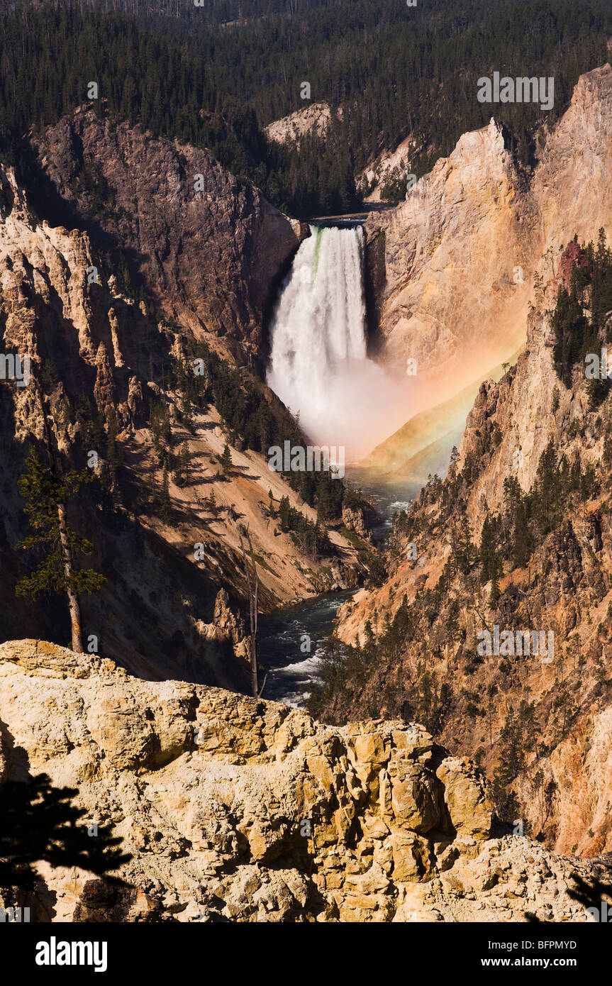 Rainbow at the lower falls of Yellowstone River Stock Photo