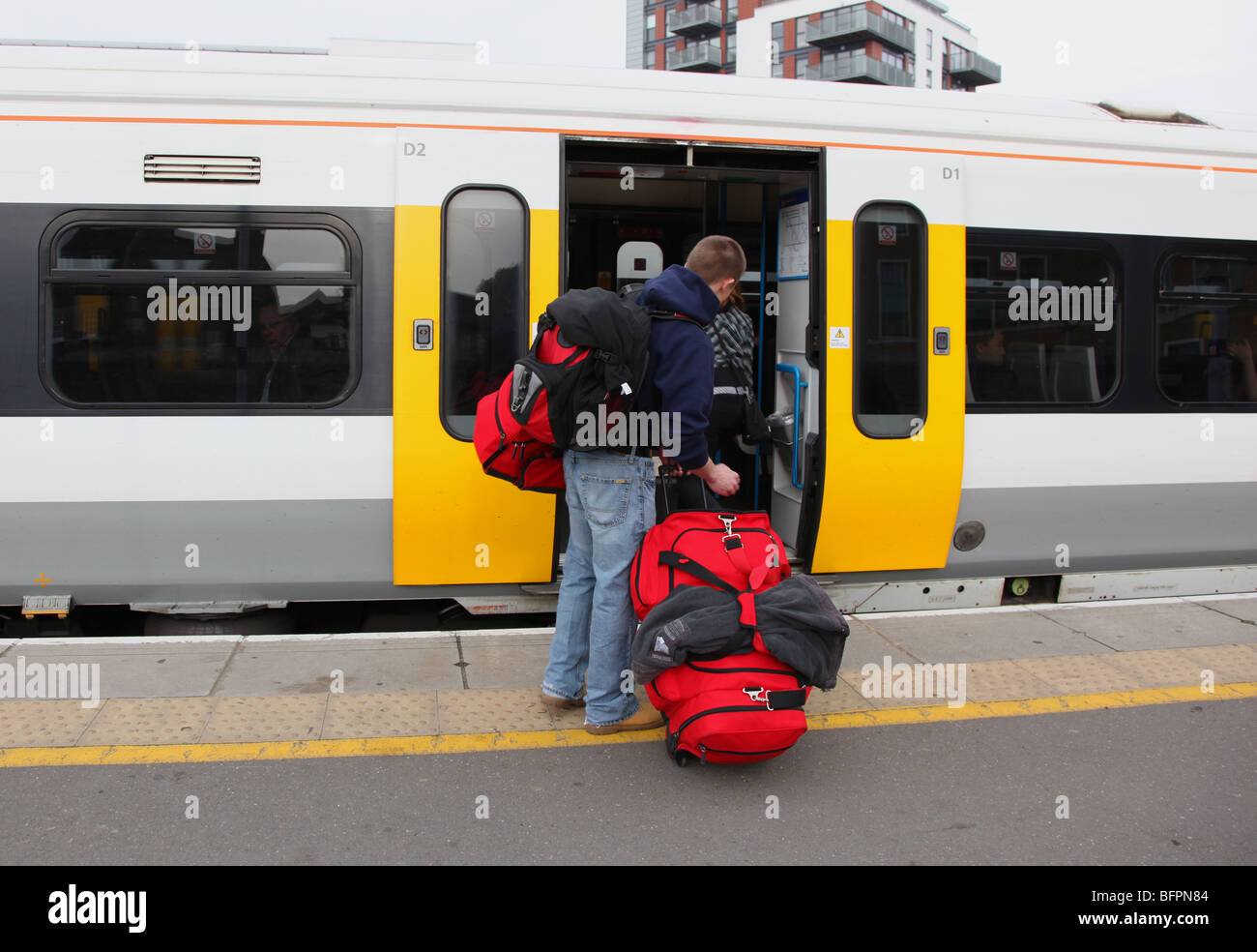 Backpacker boarding train, London UK Stock Photo - Alamy