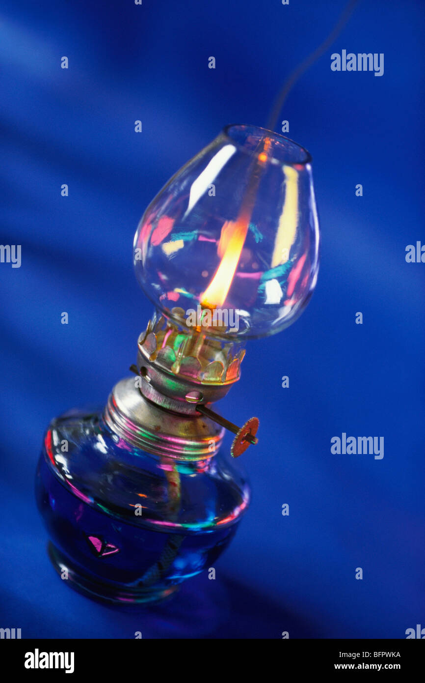 VHM 66480 : Concept ; kerosene oil lamp on blue background Stock Photo