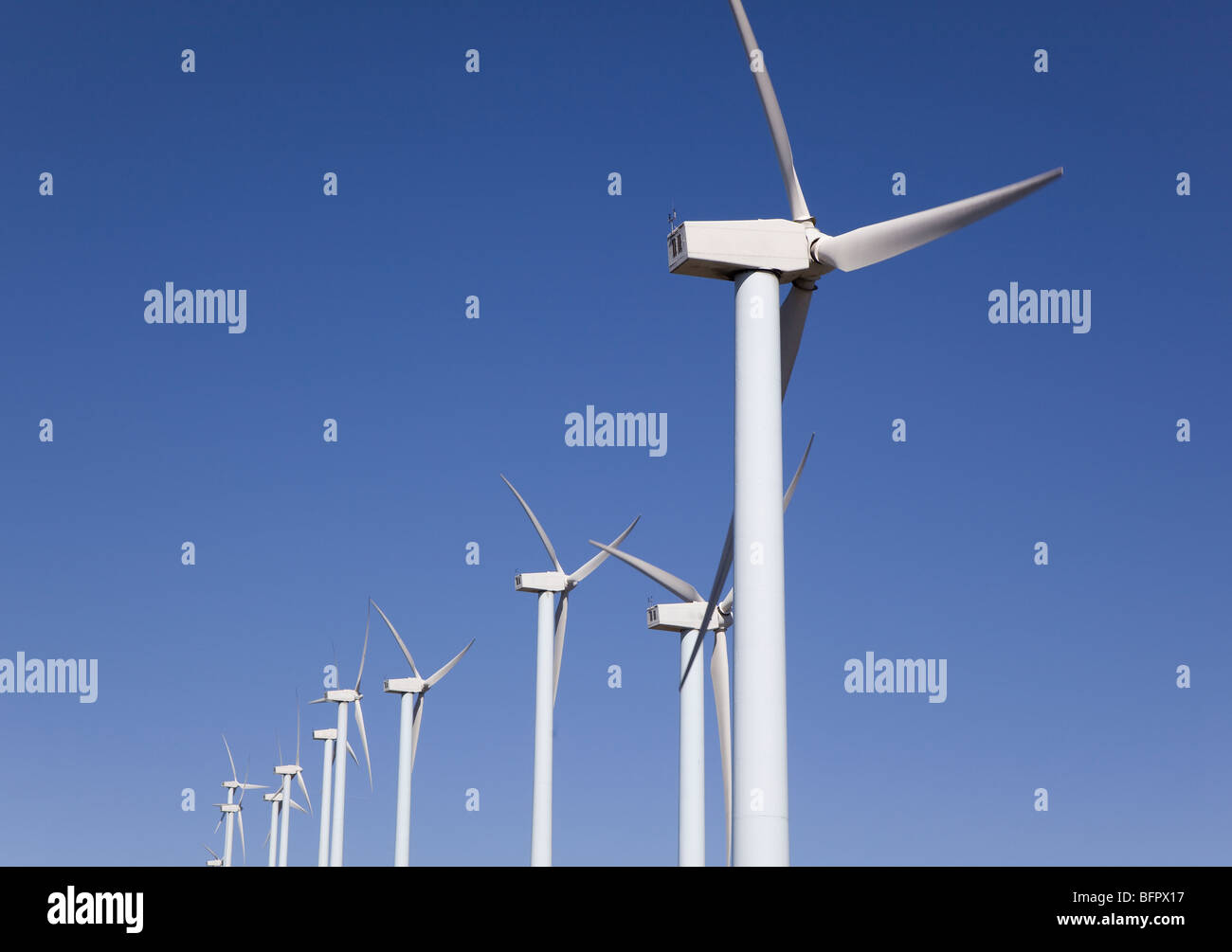 wind turbines renewable power over a blue sky Stock Photo