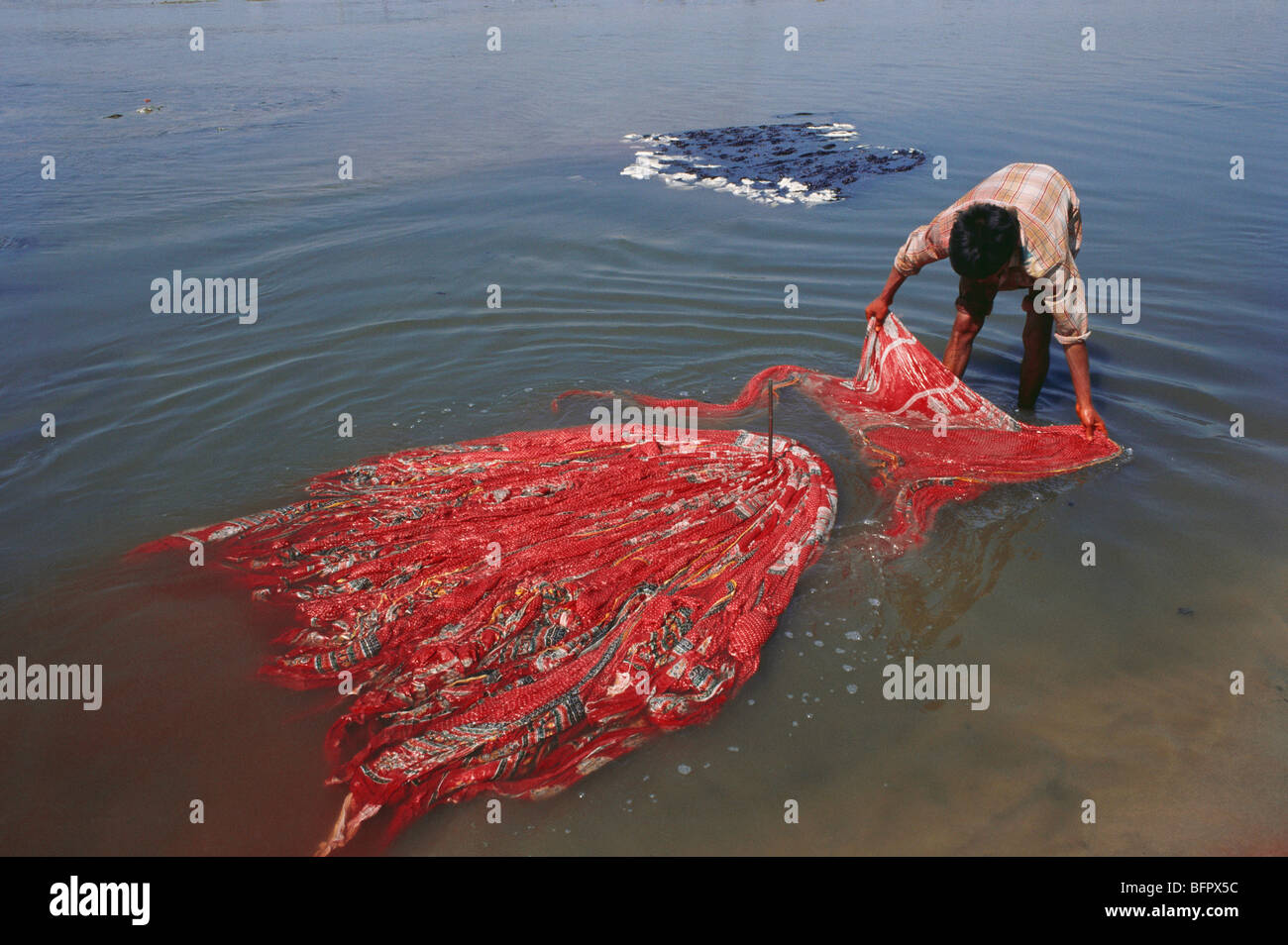 Polluting river by washing hand printed textile ; Ahmedabad ; Gujarat ; India Stock Photo