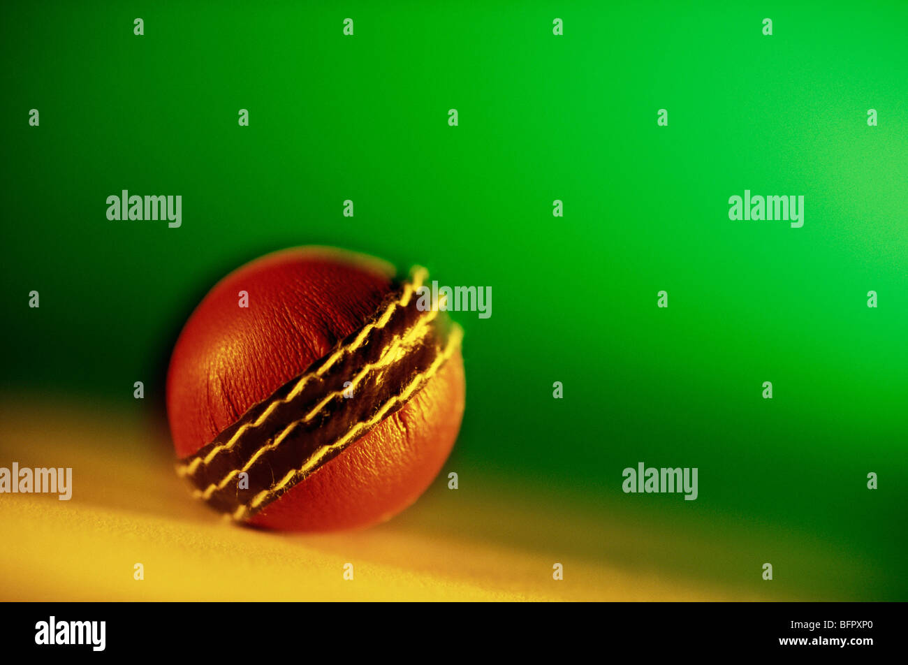 VHM 66695 : Brown cricket ball against green background Stock Photo