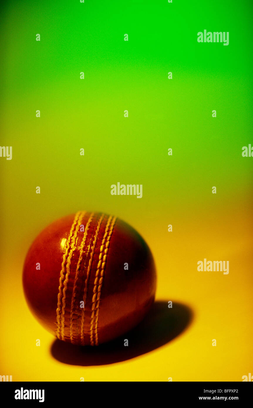 VHM 66696 : Brown cricket ball against green background Stock Photo