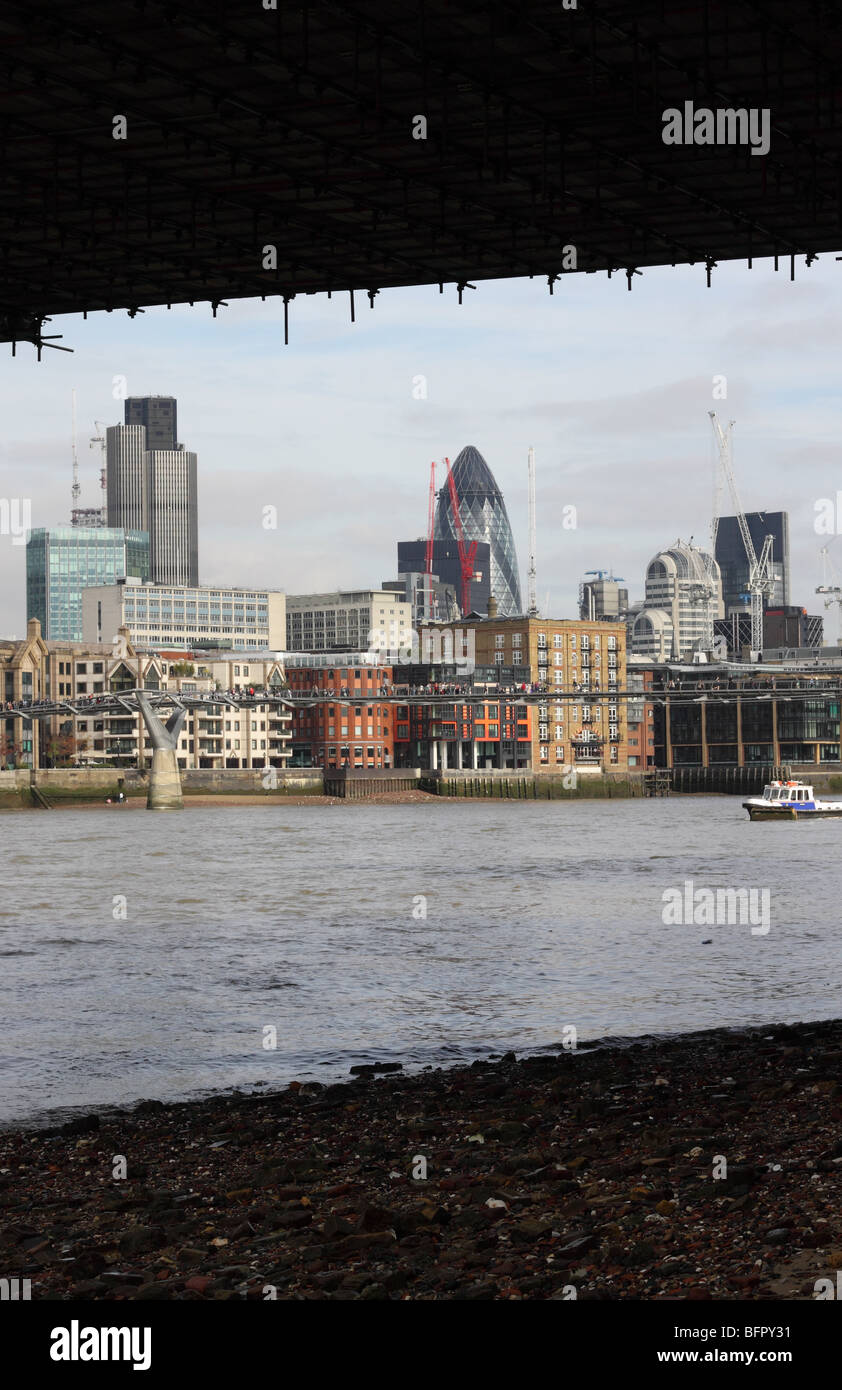 London the City skyline seen from the South Bank shore of the River Thames under Southwark Bridge Stock Photo