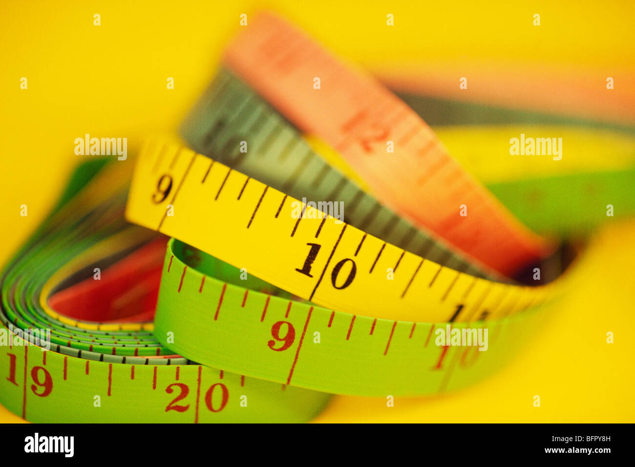 VHM 66710 : Tailor measuring tape on yellow background Stock Photo