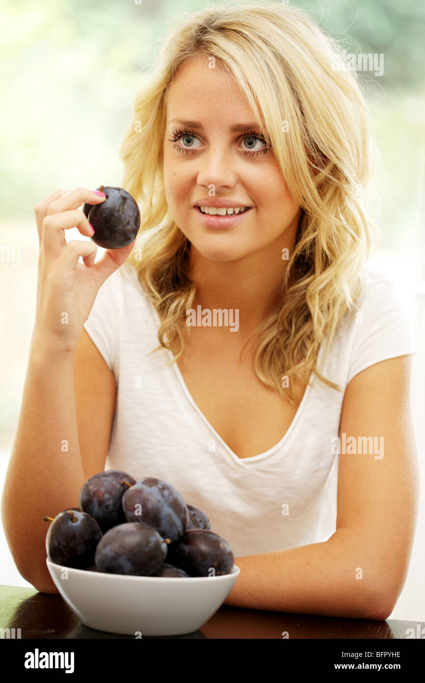 Teenage Girl Eating Plums. Model Released Stock Photo Alamy
