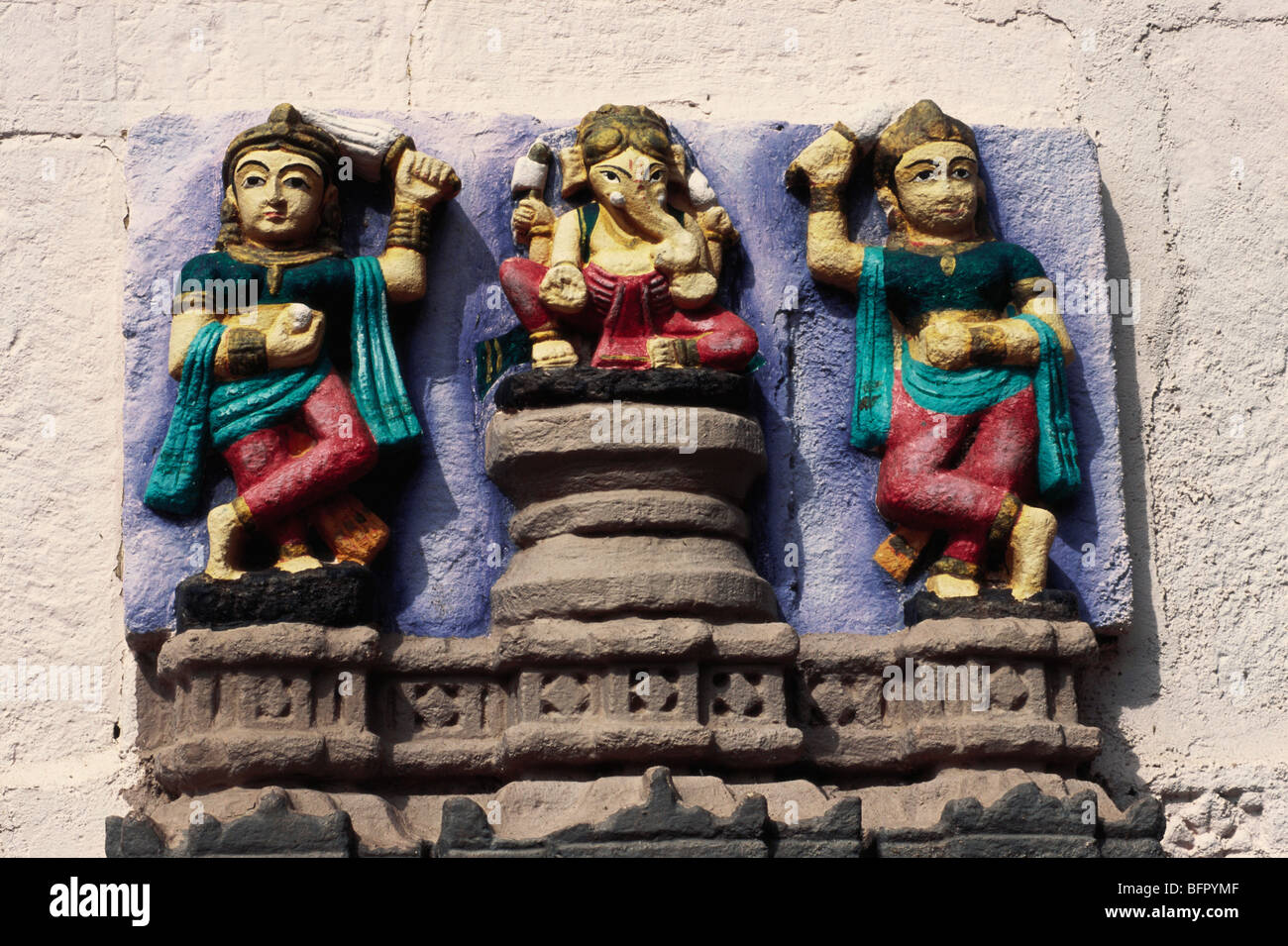 NMK 66802 : Lord Ganesh with wives riddhi and siddhi colourful Idol on temple at Sayla ; Gujarat ; India Stock Photo