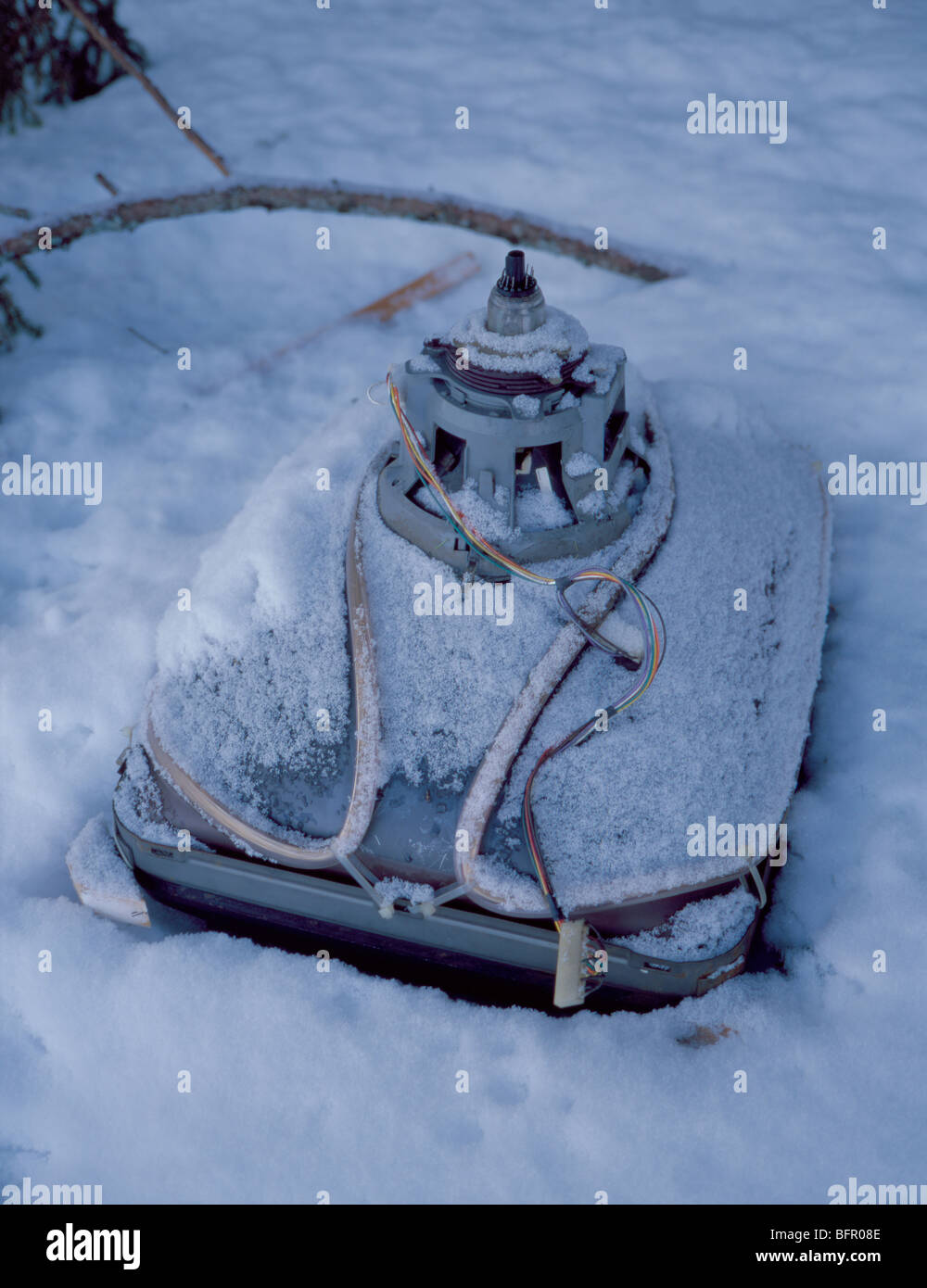 Old cathode ray tube (CRT) television (TV) fly tipped in winter snow. Stock Photo