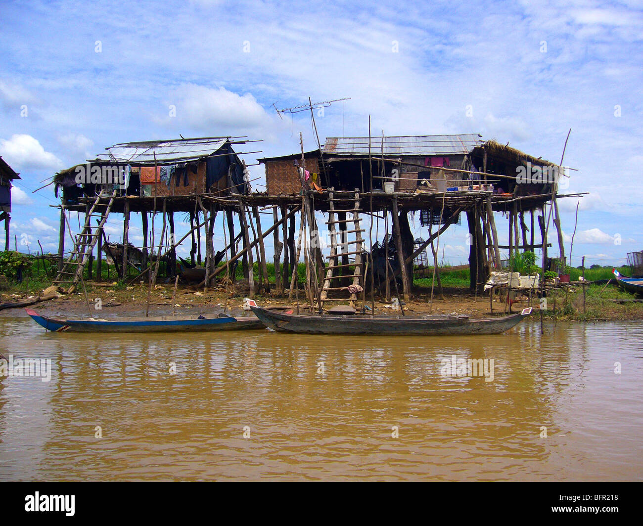 Stilted riverside dwellings line the Mekong River, one of the important waterways in Cambodia Stock Photo