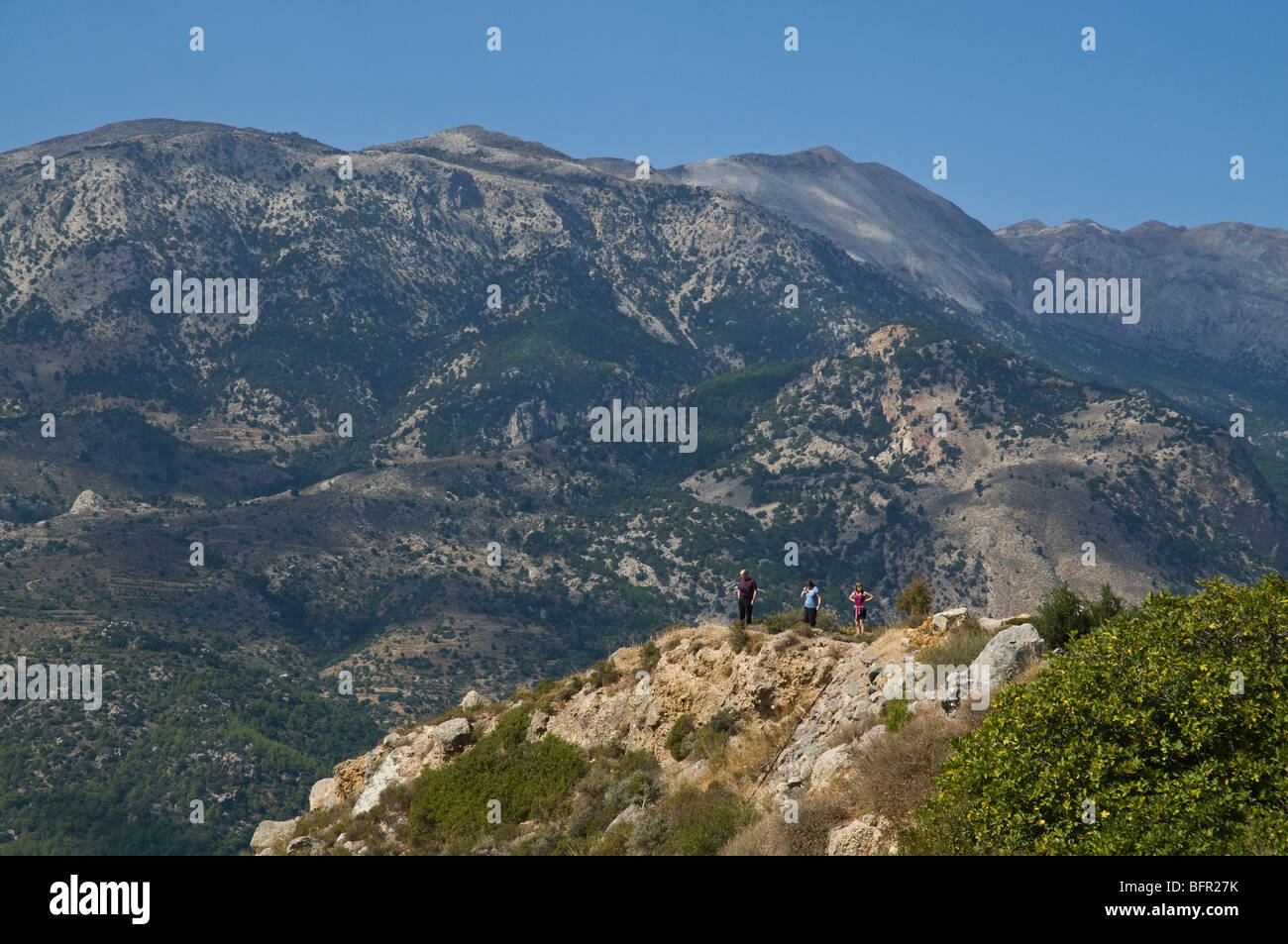 dh  IERAPETRA GREECE CRETE Tourists viewpoint viewing valley and Cretan Dikti mountains landscape holiday makers people countryside islands Stock Photo