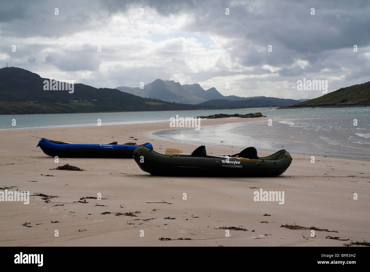 Two Sevylor Inflatable canoes on a spit of beach extending from Rabbit Islands, Tongue Bay near Tongue, Lairg, Scotland Stock Photo