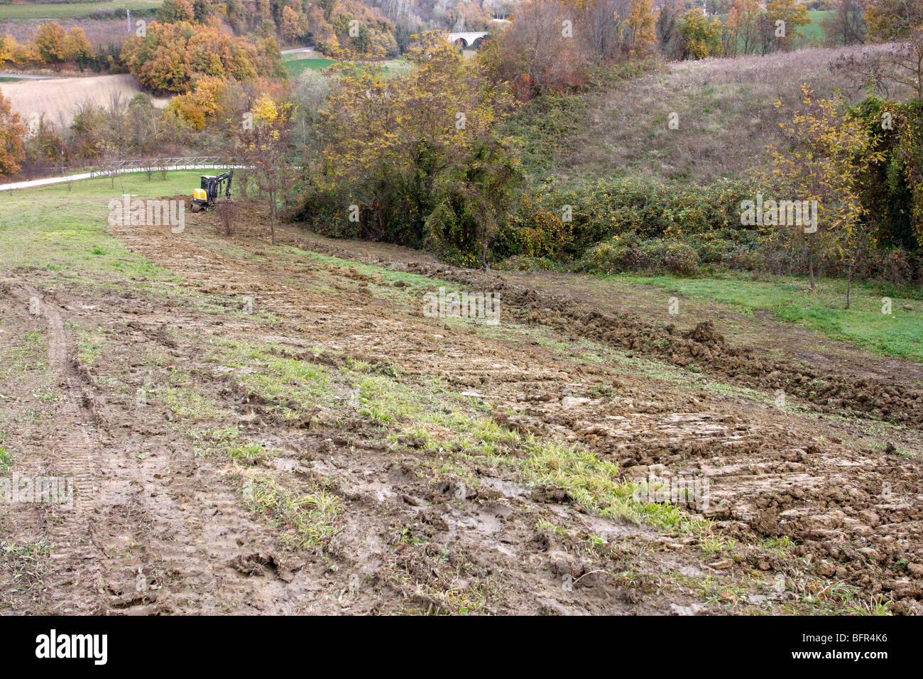 Result of excavating earth trenching  in a field to lay Geothermal Heating loops for a private house in Italy Stock Photo