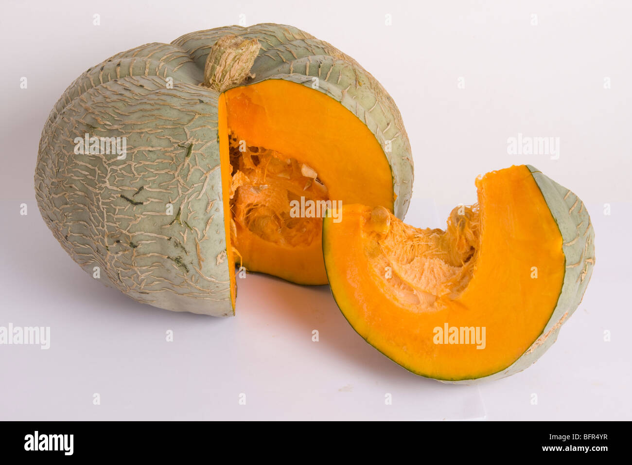 Whole pumpkin with a slice cut out Stock Photo