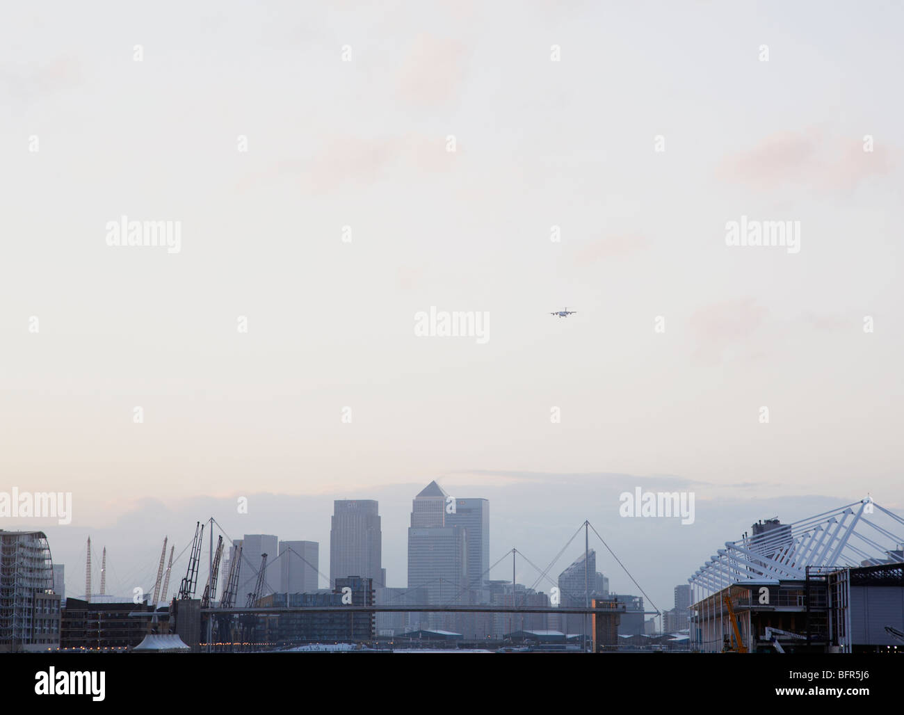 plane on its approach into London City Airport with view of Canary ...