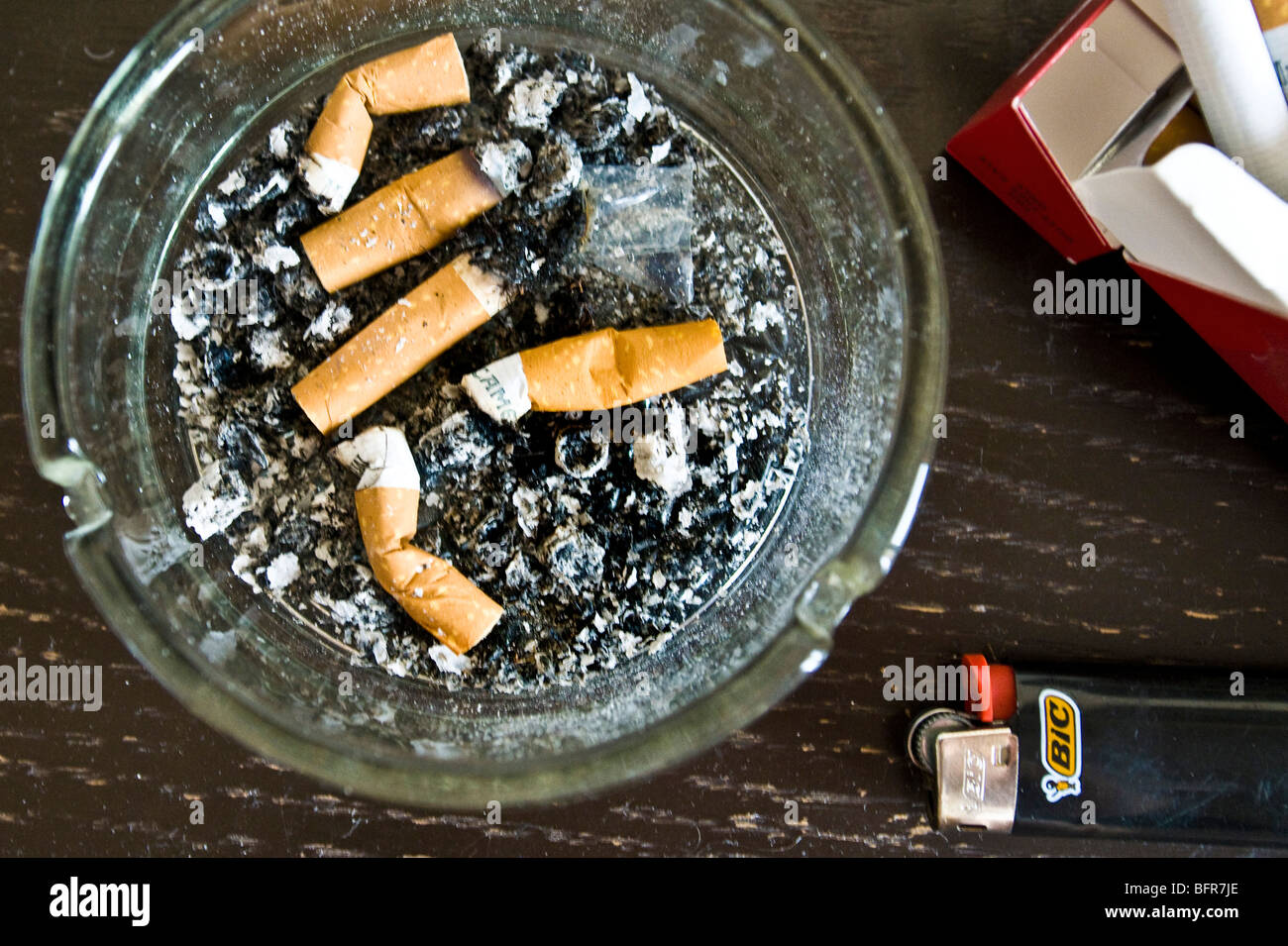 Dirty ashtray with packet of cigarettes and lighter Stock Photo Alamy