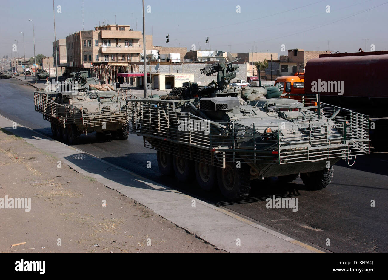 U.S. Army soldiers patrolling in Stryker armored wheeled vehicles as part of Operation Block Party. Stock Photo