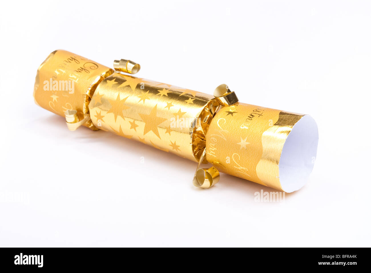 Golden christmas cracker isolated against white background. Stock Photo