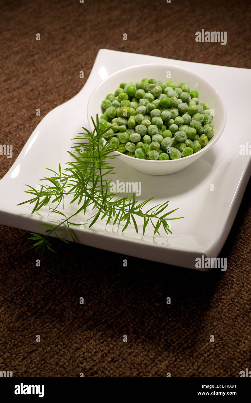 Still life image of green peas and herbs Stock Photo