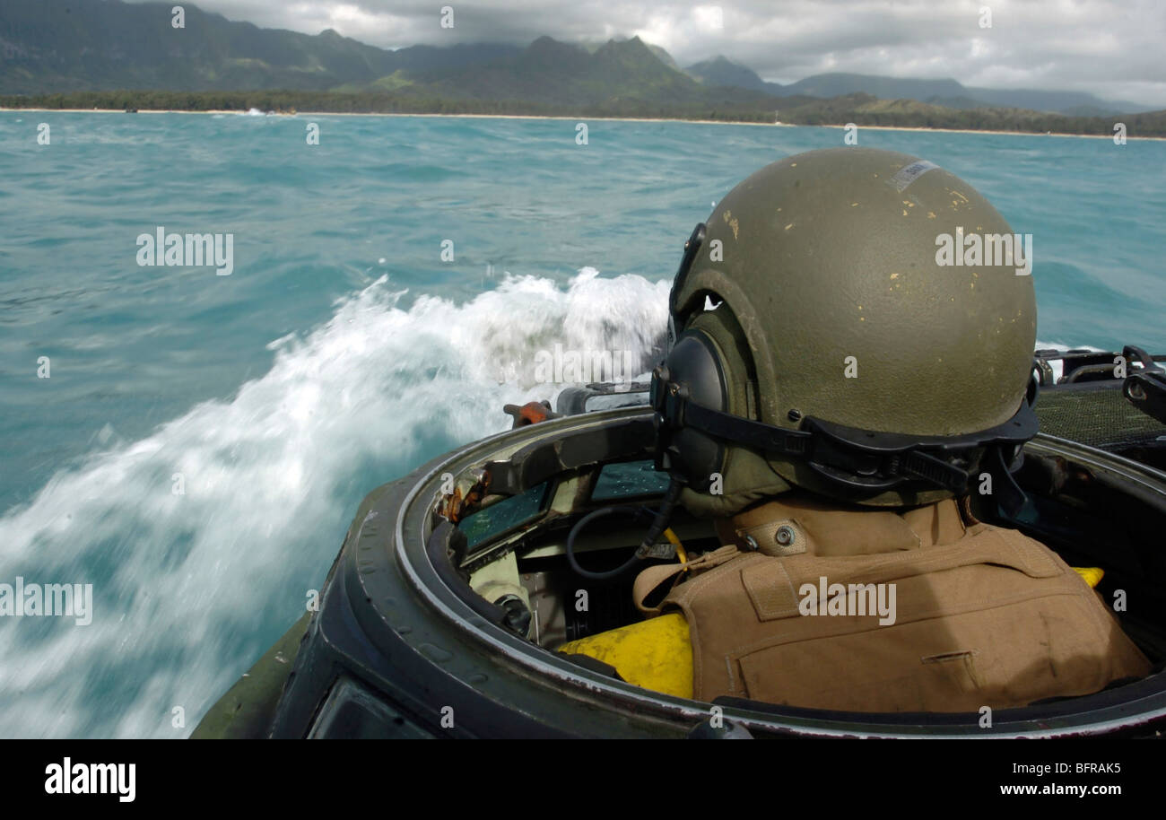U.S. Marine driving an amphibious assault vehicle through the Pacific Ocean on coast of Hawaii. Stock Photo