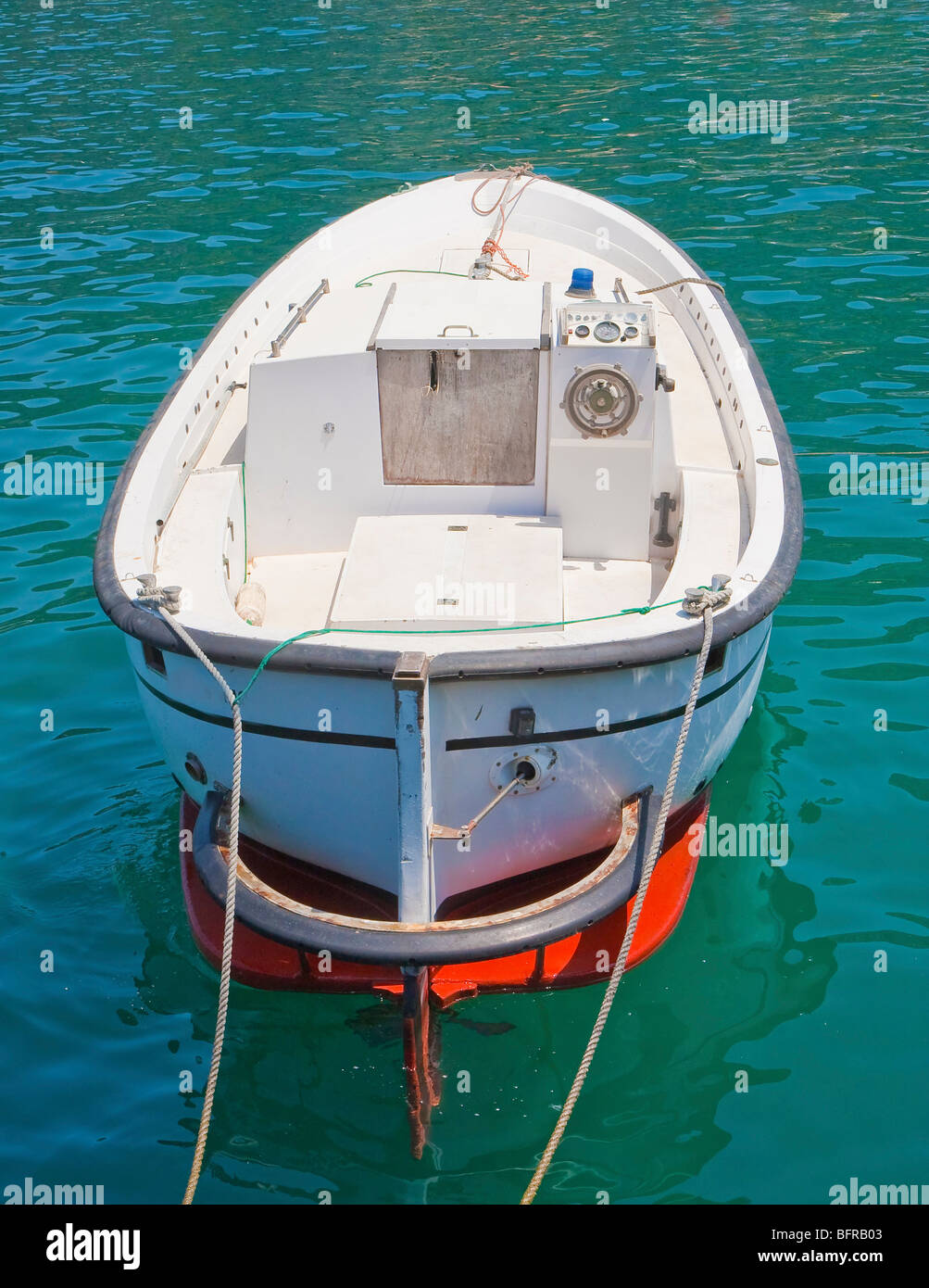 A small motor boat tied to a pier Stock Photo - Alamy