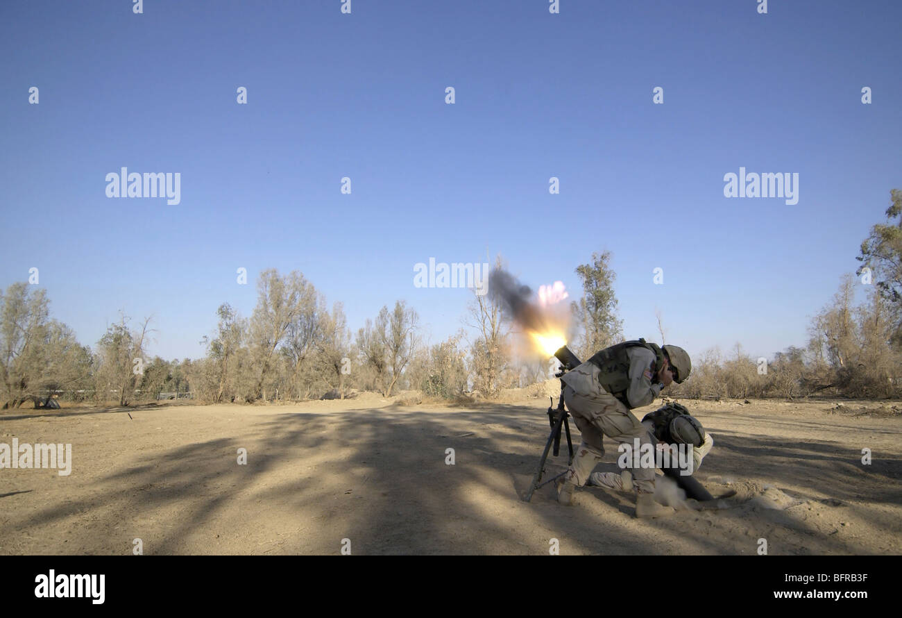 U.S. Army soldiers firing a 120-millimeter mortar round from Forward Operating Base Wilson in Iraq. Stock Photo
