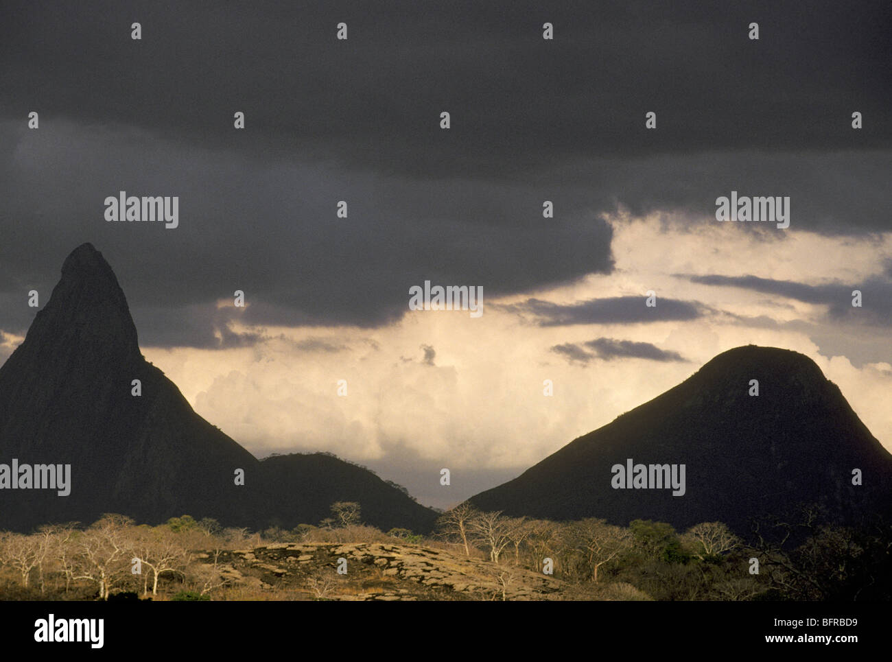 Peaks of Mount Lema range silhouetted against thick bank of white cloud Stock Photo