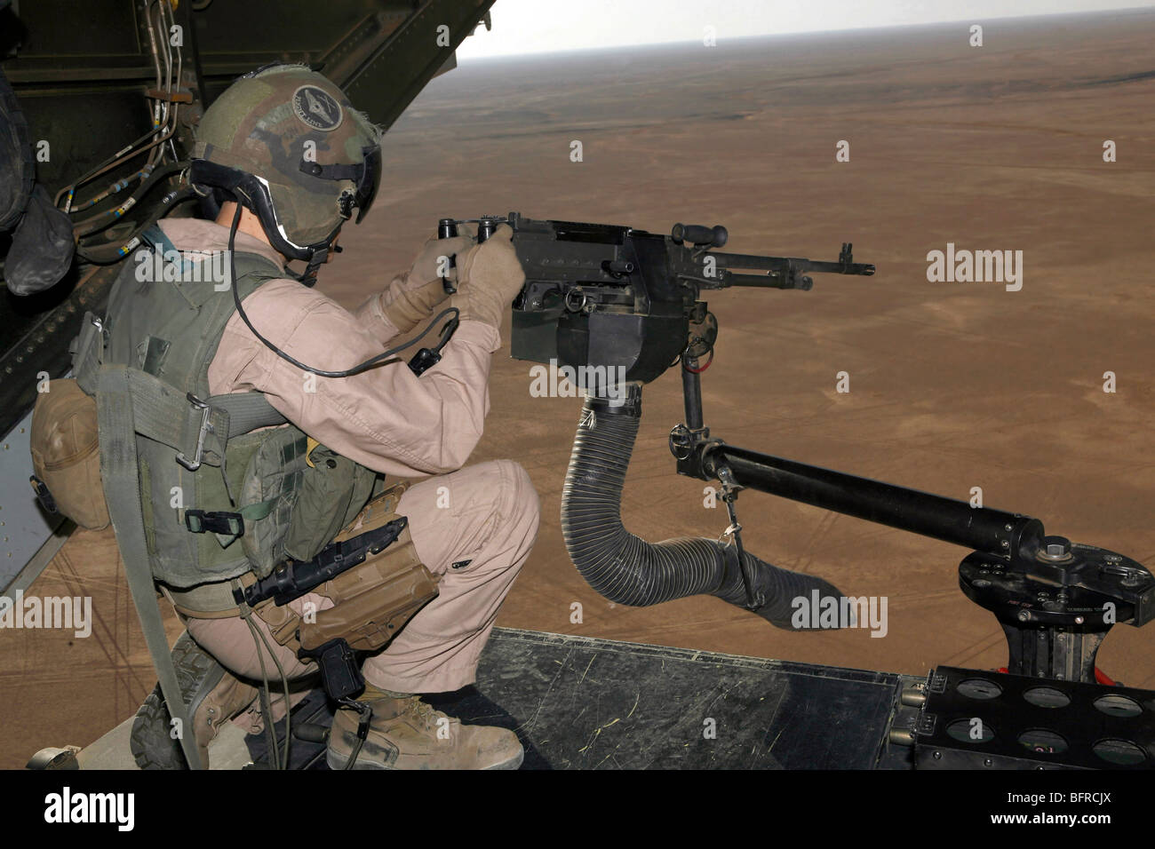 U.S. Marine test firing an M240 heavy machine gun on the back of a MV-22B Osprey. Stock Photo
