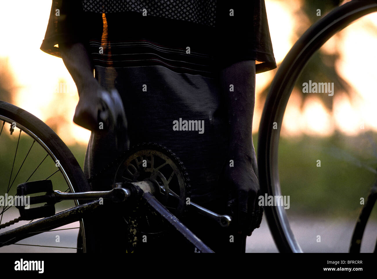 Youth repairing bicycle Stock Photo