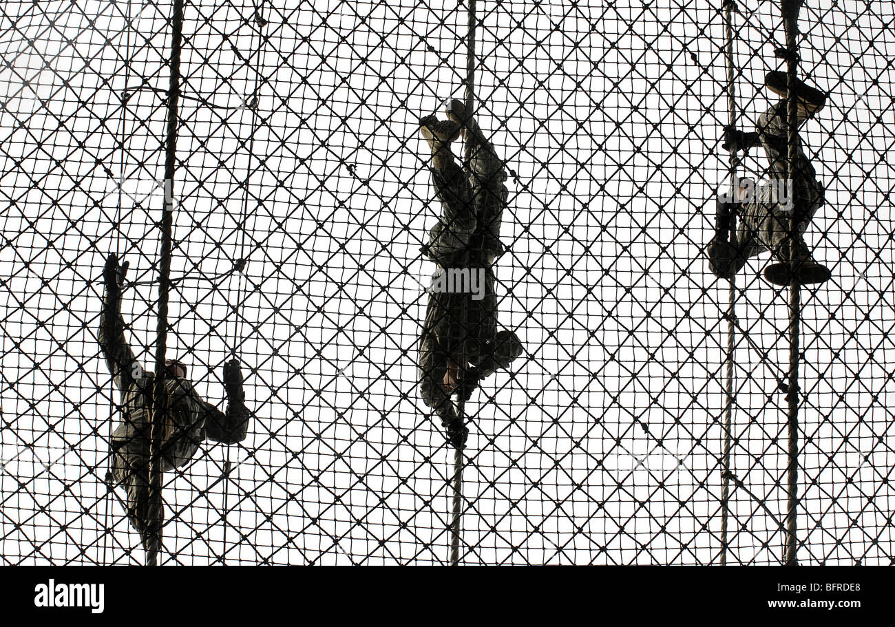 U.S. Army recruits completing an obstacle at Victory Tower during basic combat training. Stock Photo