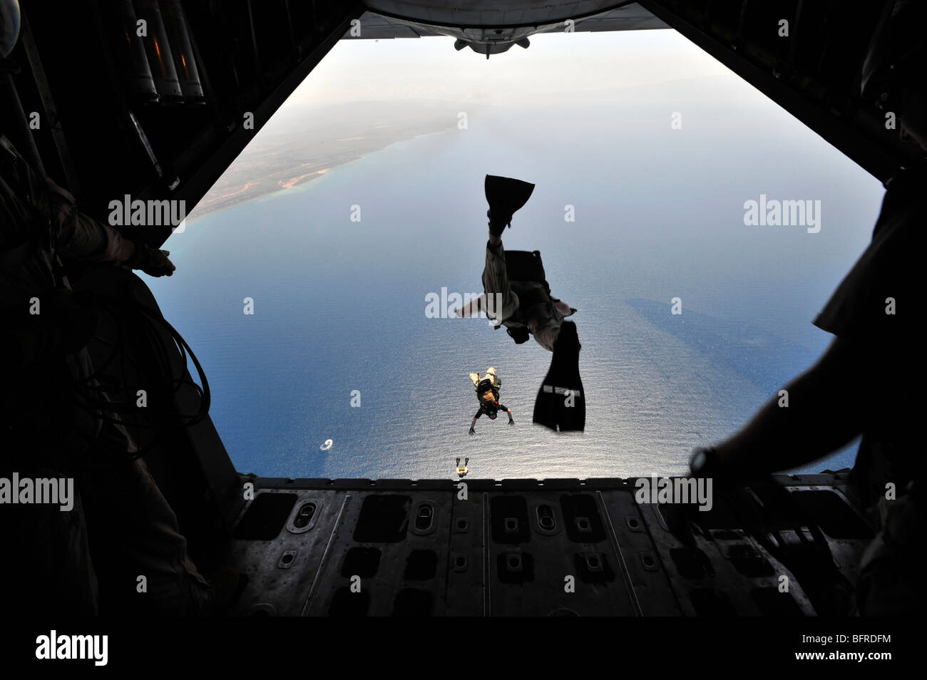 A U.S. Air Force pararescueman jumping out of an HC-130P Hercules aircraft. Stock Photo