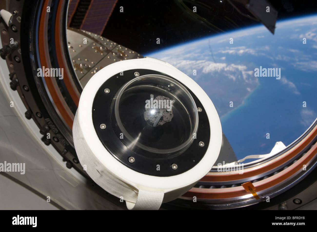 A moon rock floats aboard the International Space Station. Stock Photo