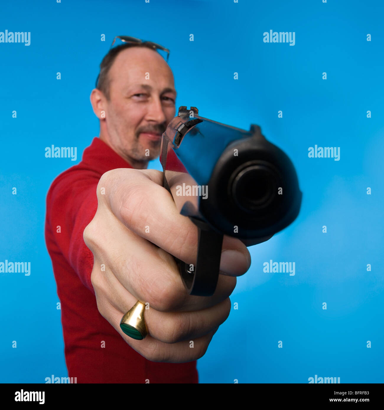 Serious man holding pistol pointing hires stock photography and images